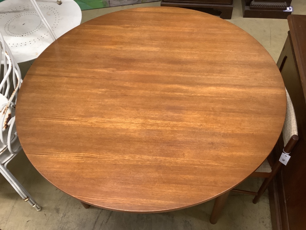 A mid century design Macintosh circular teak extending dining table and four chairs, model 9533, table width 170cm extended depth 122cm height 74cm